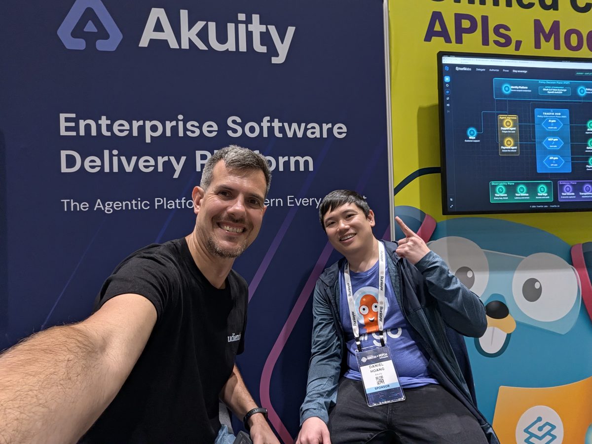Luca Berton and Daniel Hoang at the Akuity booth, under a banner reading Enterprise Software Delivery Platform