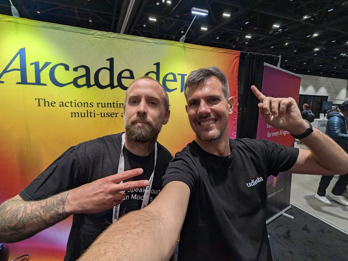 Luca Berton and Nathan Slavik in front of the Arcade.dev banner