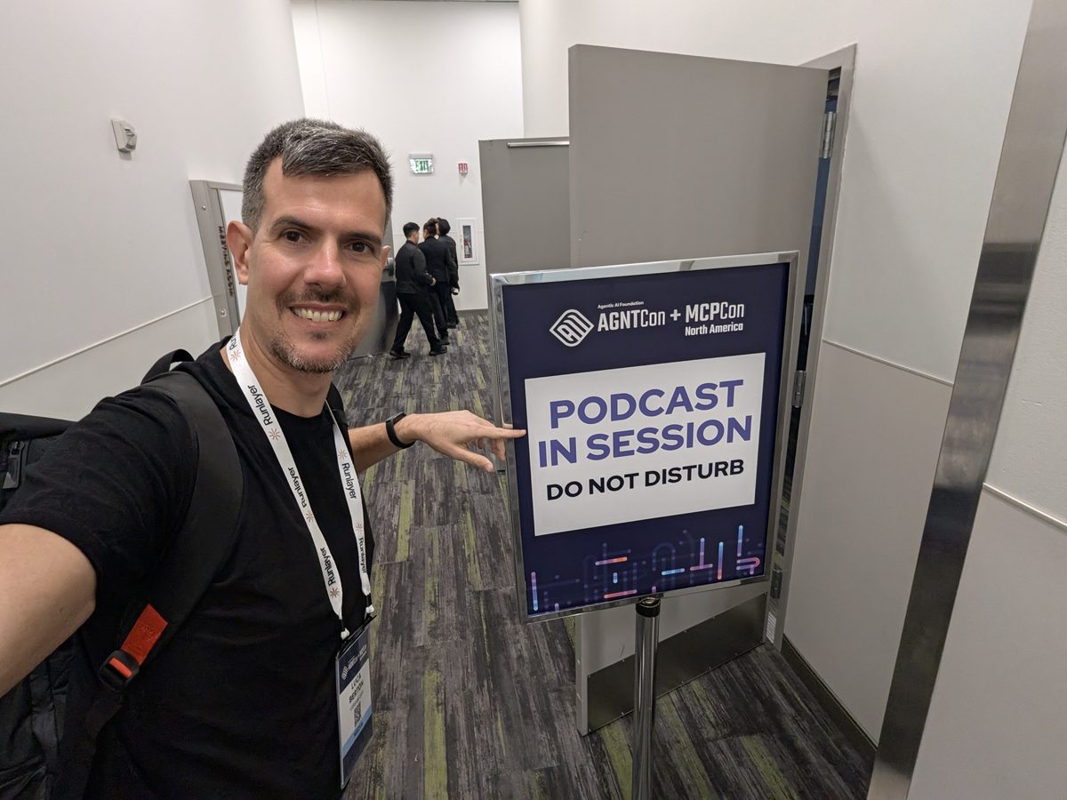 Luca Berton pointing at an AGNTCon + MCPCon sign reading Podcast in session, do not disturb