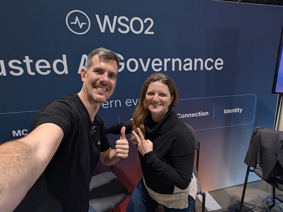 Luca Berton and Rania Khalaf at the WSO2 booth, under a banner about trusted AI governance