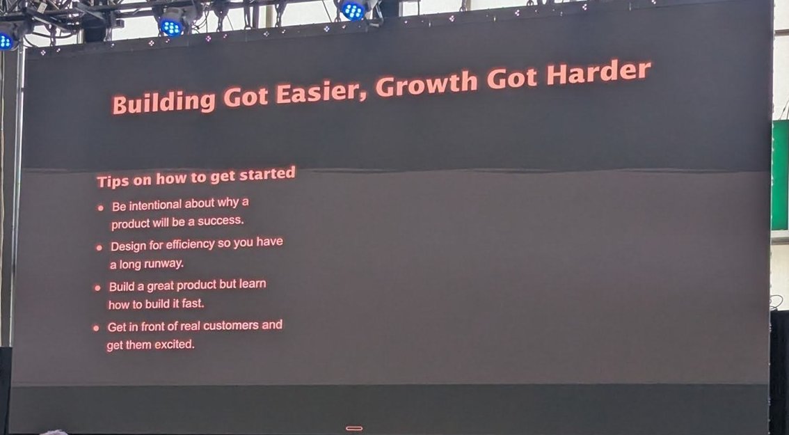 A stage screen reading Building Got Easier, Growth Got Harder, with four tips on how to get started