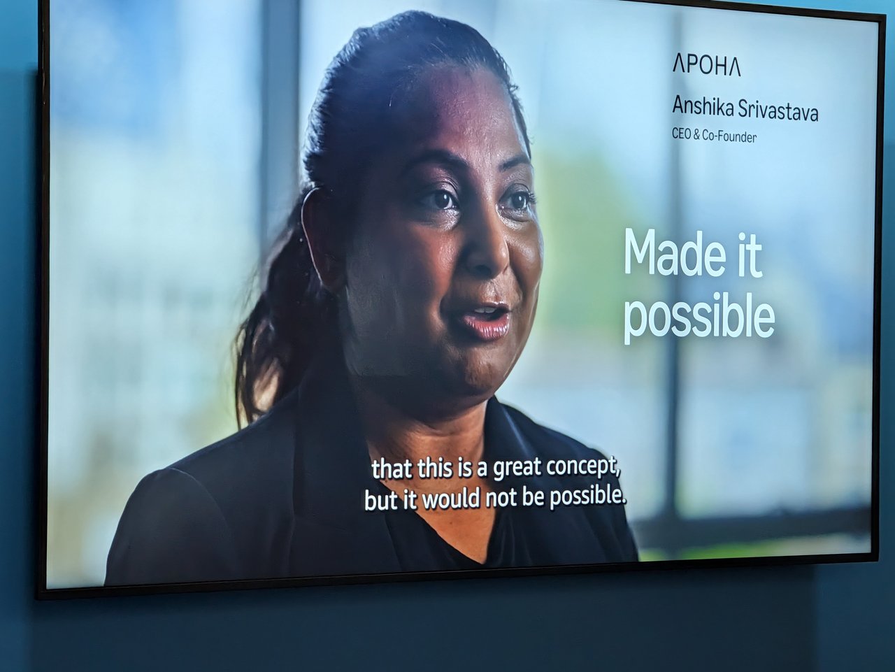 A stand screen playing a video interview with Anshika Srivastava, CEO and co-founder of Apoha