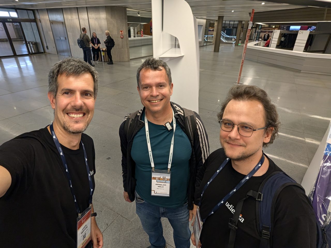 The host with Arnaldo Carvalho de Melo of Red Hat, wearing a lavalier microphone, and Marcin Czupryniak
