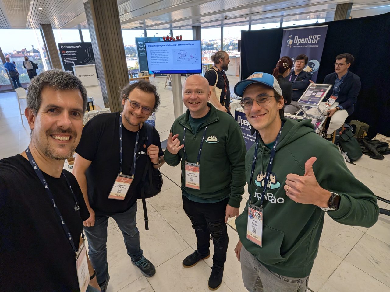 The host, Marcin Czupryniak, Andrii Fedorchuk and Toni Tauro near the OpenSSF booth