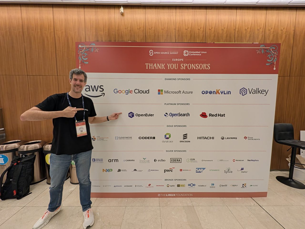 The host in front of the Open Source Summit Europe 2026 sponsor wall