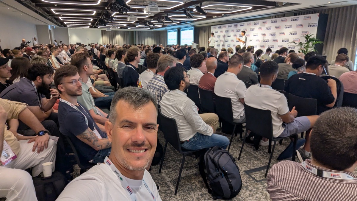A packed conference room at PlatformCon Live Day London, every seat taken, with two speakers on stage against a PlatformCon backdrop